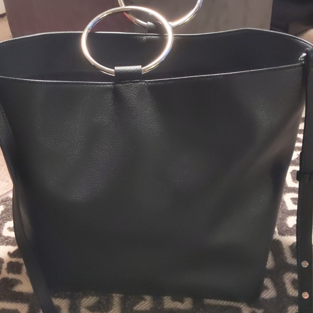 Black tote with silver round handles.